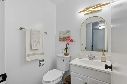 a bathroom with a sink mirror and toilet