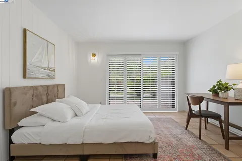 a bedroom with a bed and a table