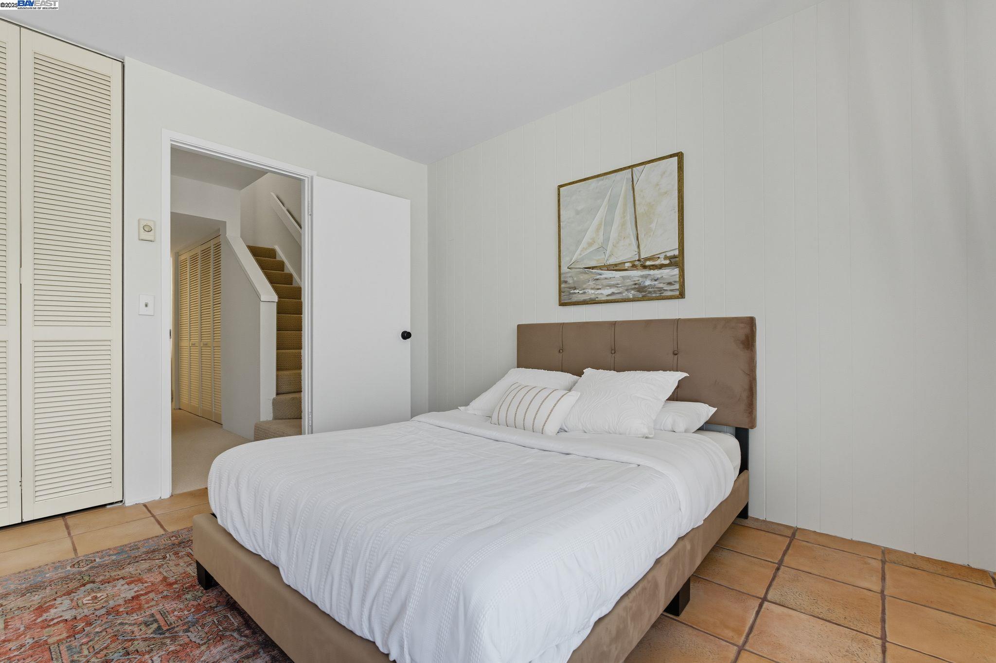 2101 Shore Line Drive, Unit 233 Alameda, CA 94501 - Photo 32 of 47 a bedroom with a bed and a painting on the wall