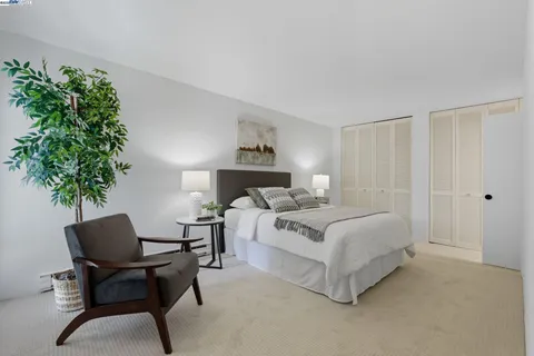 a bed room with a bed and a chair