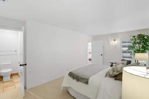 a bedroom with a bed and a table