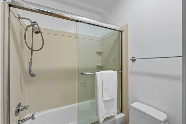 a bathroom that has a shower and a toilet