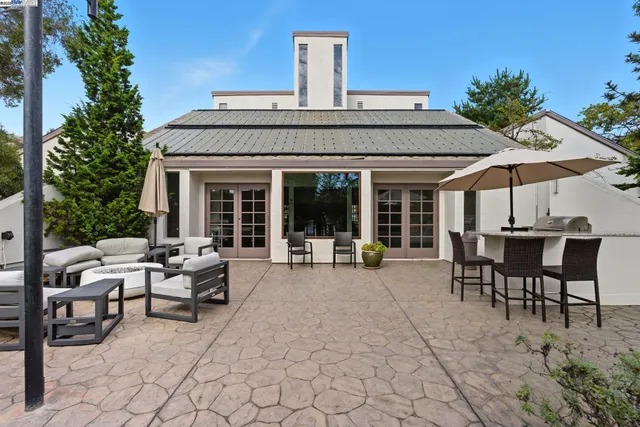 a view of a house with backyard sitting area and garden