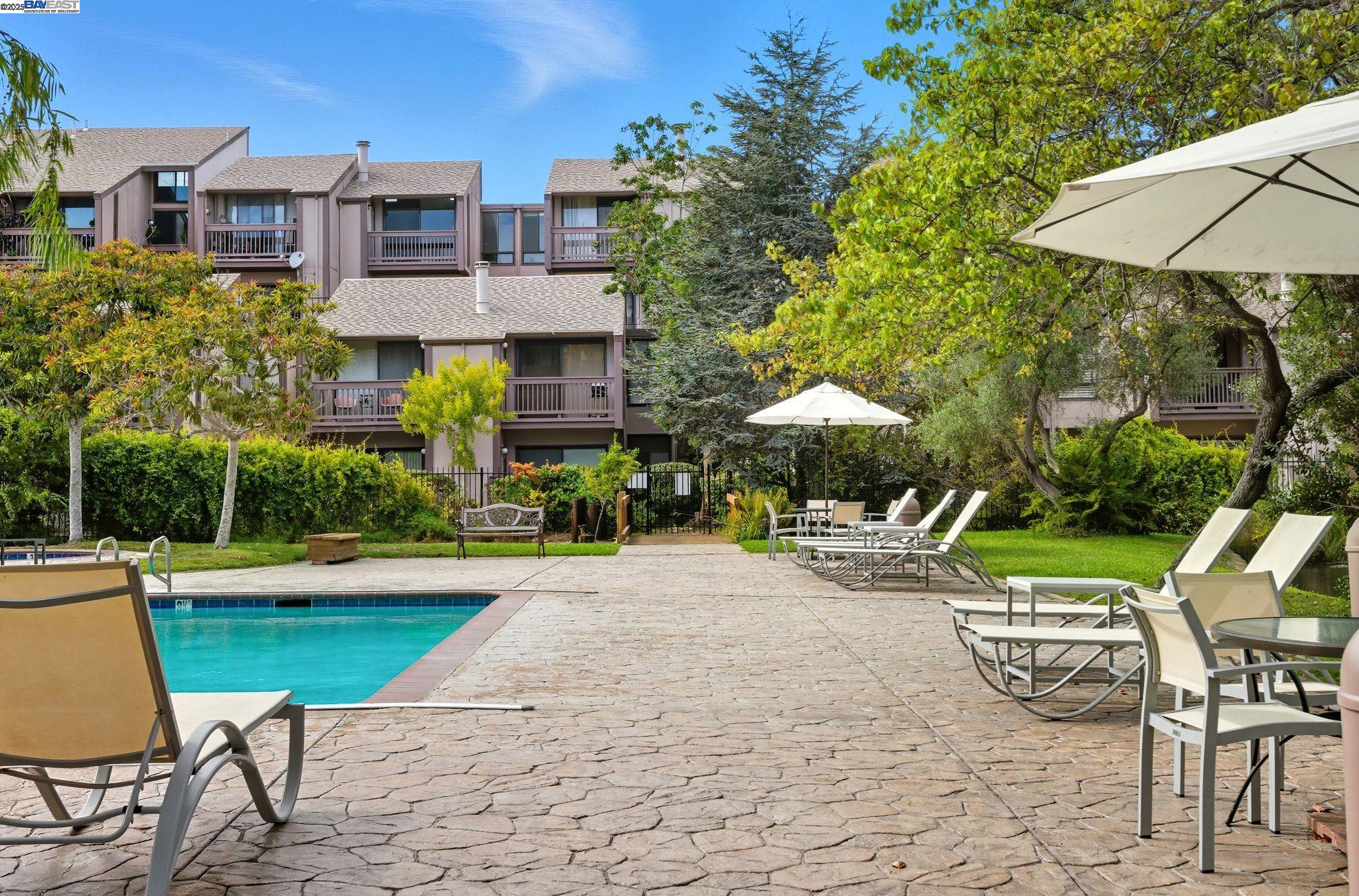 2101 Shore Line Drive, Unit 233 Alameda, CA 94501 - Photo 10 of 47 a patio with a table and chairs under an umbrella