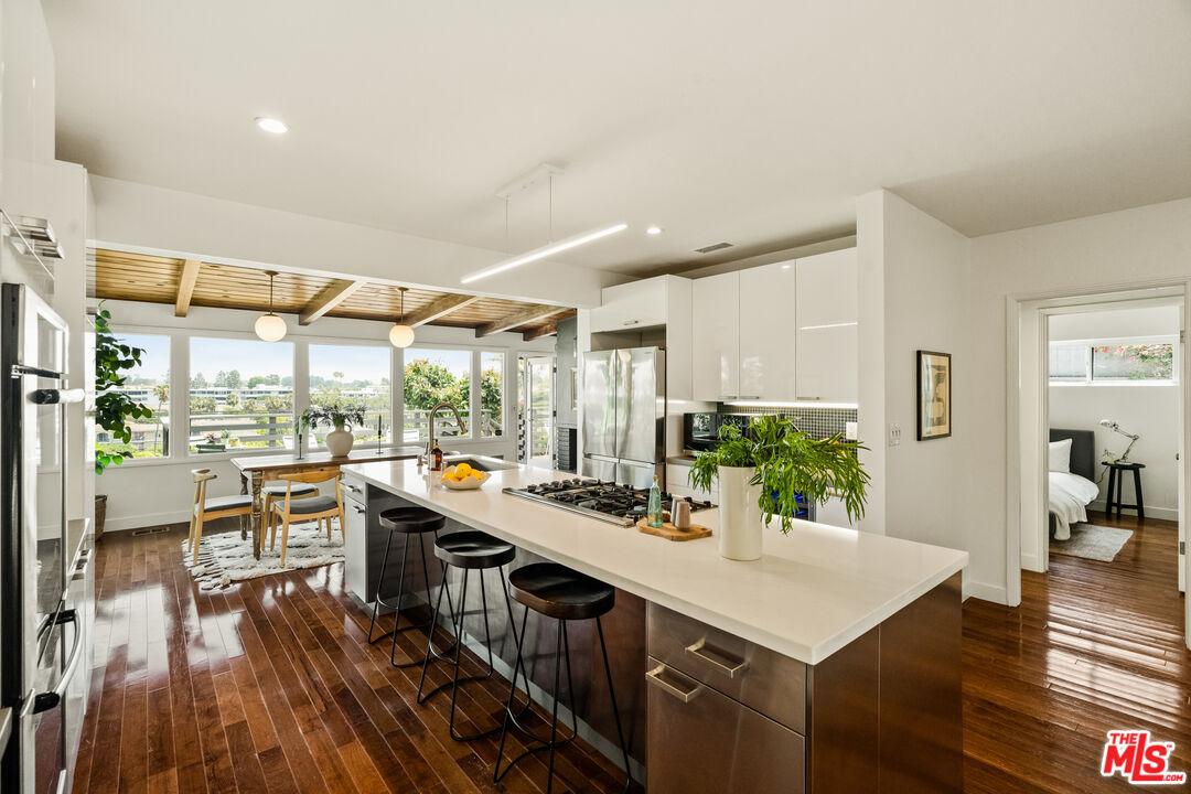 7406 Earldom Avenue Playa del Rey, CA 90293 - Photo 16 of 61 a kitchen with a sink a stove and wooden floor