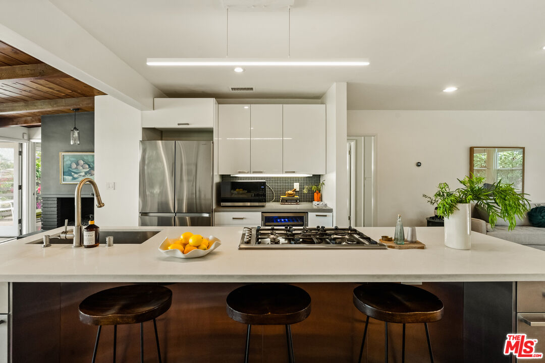 7406 Earldom Avenue Playa del Rey, CA 90293 - Photo 17 of 61 a kitchen with a table chairs stove and refrigerator