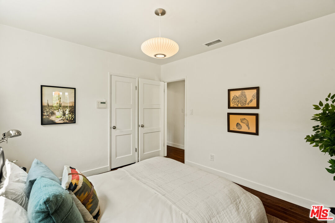 7406 Earldom Avenue Playa del Rey, CA 90293 - Photo 25 of 61 a bedroom with a bed and a chandelier