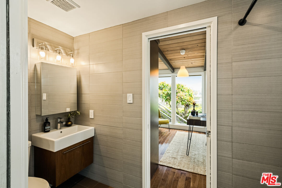7406 Earldom Avenue Playa del Rey, CA 90293 - Photo 31 of 61 a bathroom with a sink a mirror and shower