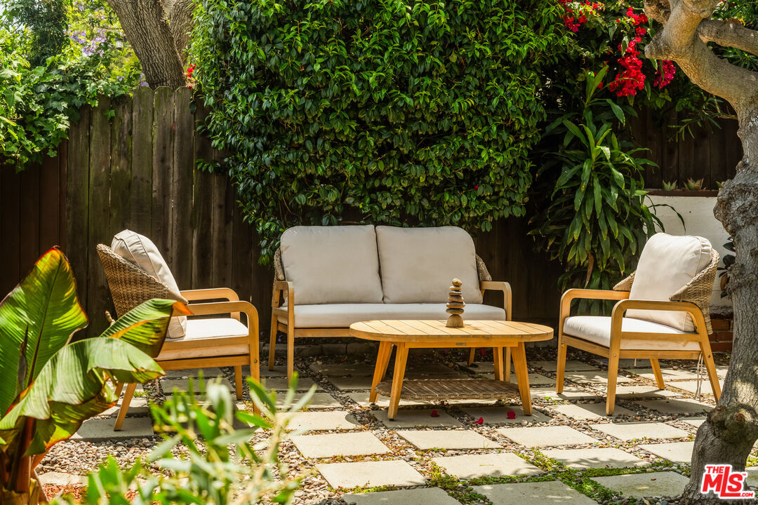 7406 Earldom Avenue Playa del Rey, CA 90293 - Photo 54 of 61 a couple of chairs sitting in a backyard with plants