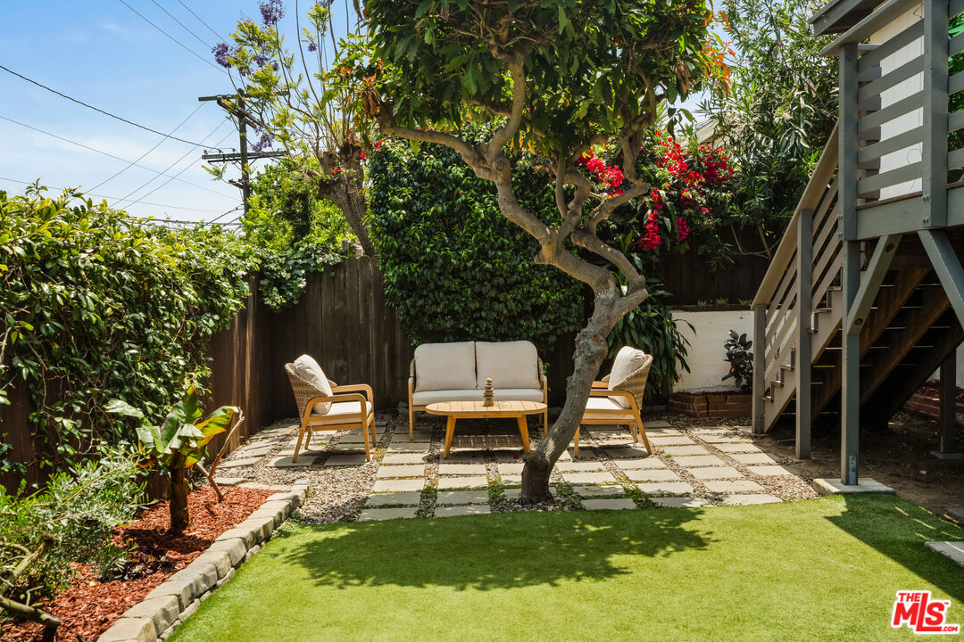 7406 Earldom Avenue Playa del Rey, CA 90293 - Photo 58 of 61 a backyard of a house with table and chairs