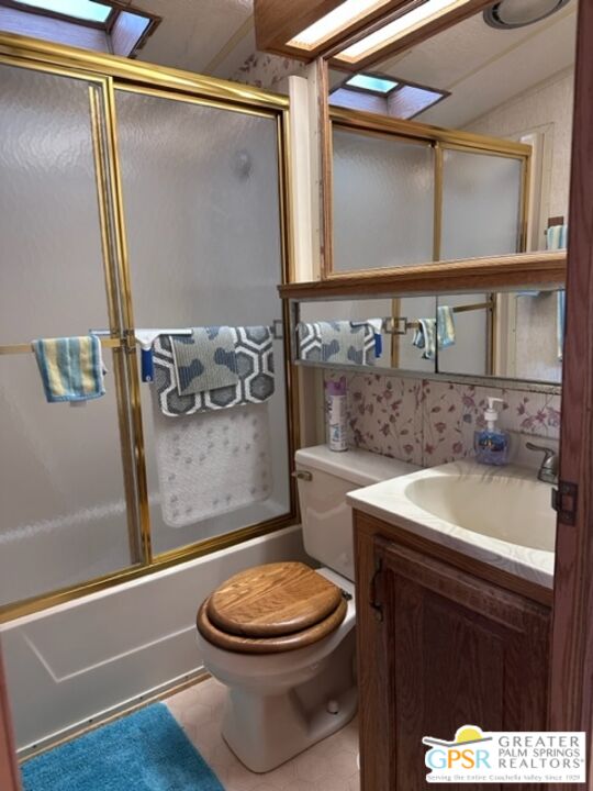 69801 Ramon Road, Unit 115 Cathedral City, CA 92234 - Photo 12 of 13 a bathroom with a sink a toilet and shower