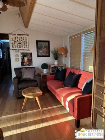 a living room with furniture and a floor to ceiling window