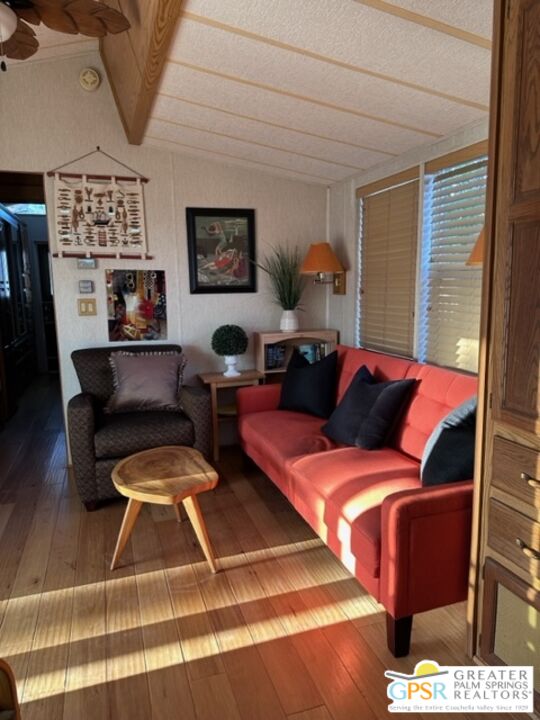 69801 Ramon Road, Unit 115 Cathedral City, CA 92234 - Photo 2 of 13 a living room with furniture and a floor to ceiling window