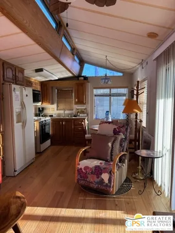 a kitchen with stainless steel appliances granite countertop a sink refrigerator and cabinets