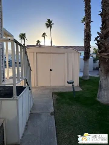 a view of a house with backyard and porch