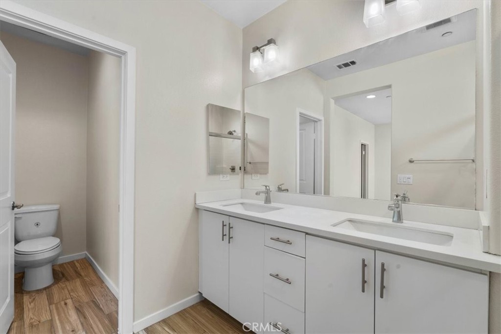 726 Central Avenue Upland, CA 91786 - Photo 26 of 42 a bathroom with a toilet sink and mirror