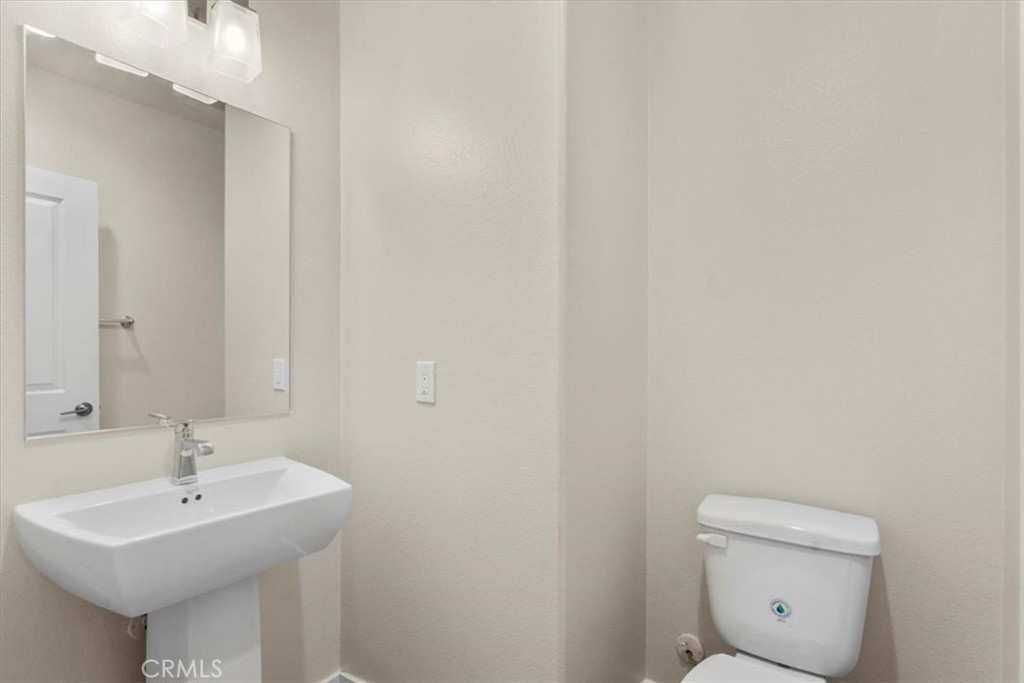 726 Central Avenue Upland, CA 91786 - Photo 29 of 42 a bathroom with a sink a toilet and mirror