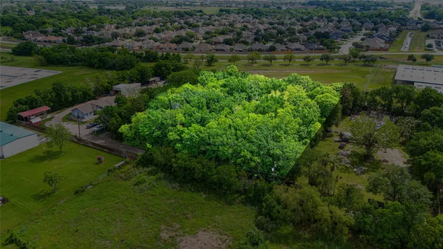 a view of a water pond with green yard