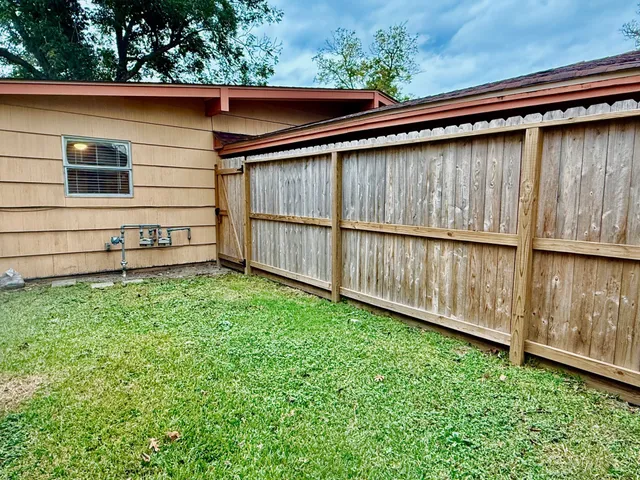 a view of a backyard with a wooden fence