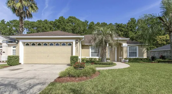 a front view of a house with a yard and garage