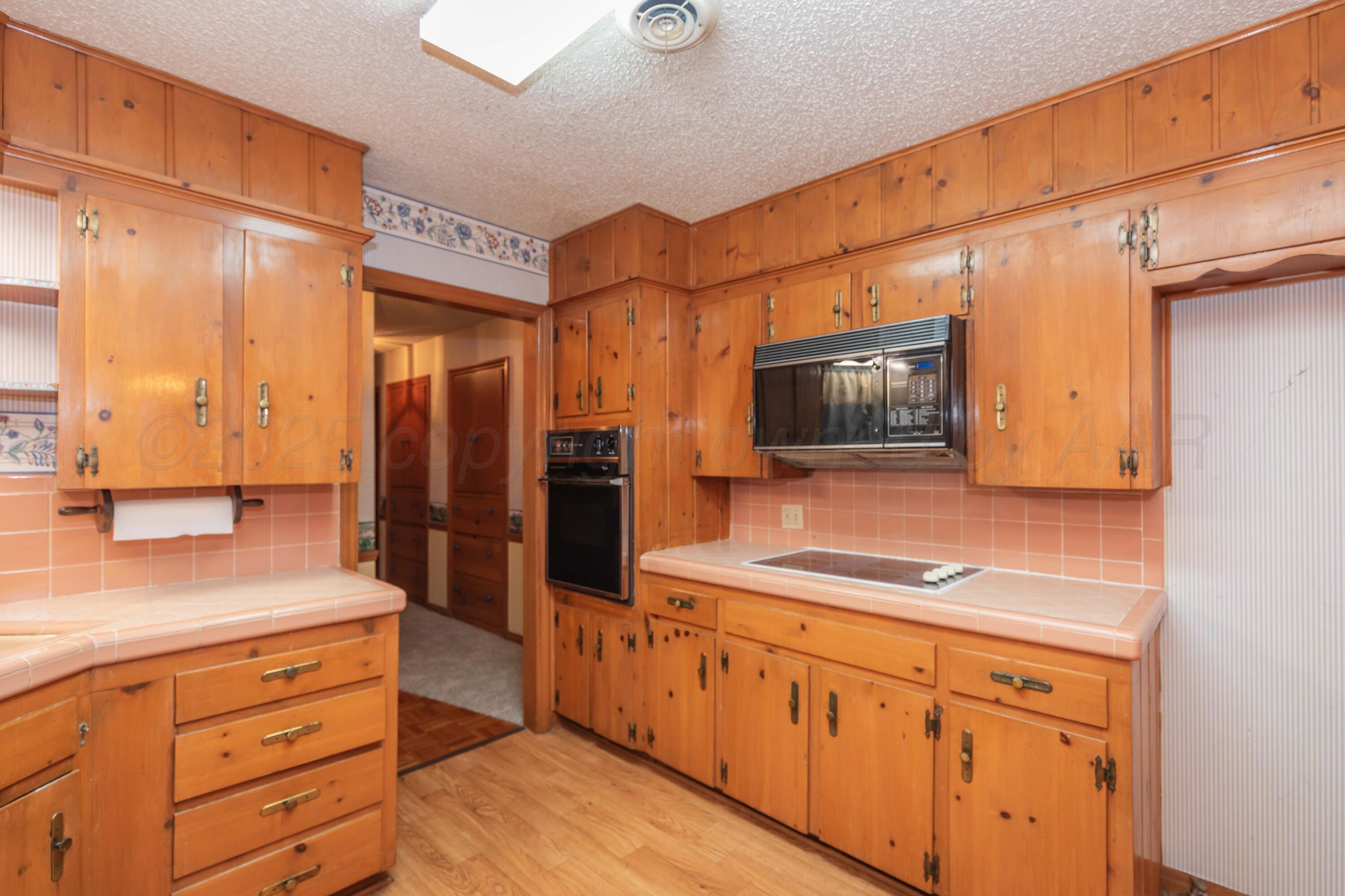 4221 Arden Road Amarillo, TX 79110 - Photo 15 of 50 a kitchen with stainless steel appliances granite countertop a sink and a refrigerator