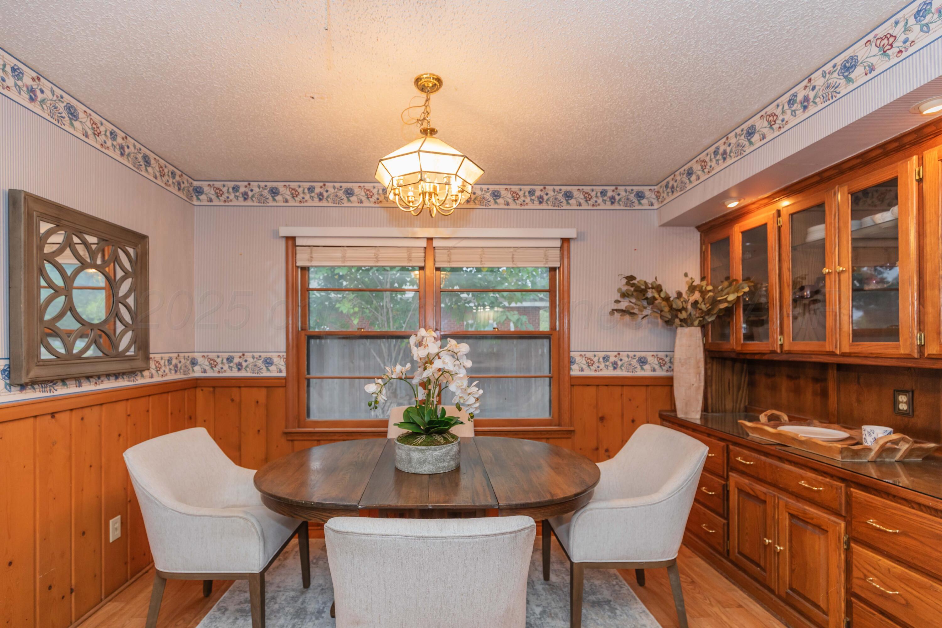 4221 Arden Road Amarillo, TX 79110 - Photo 17 of 50 a view of a dining room with furniture wooden floor and chandelier