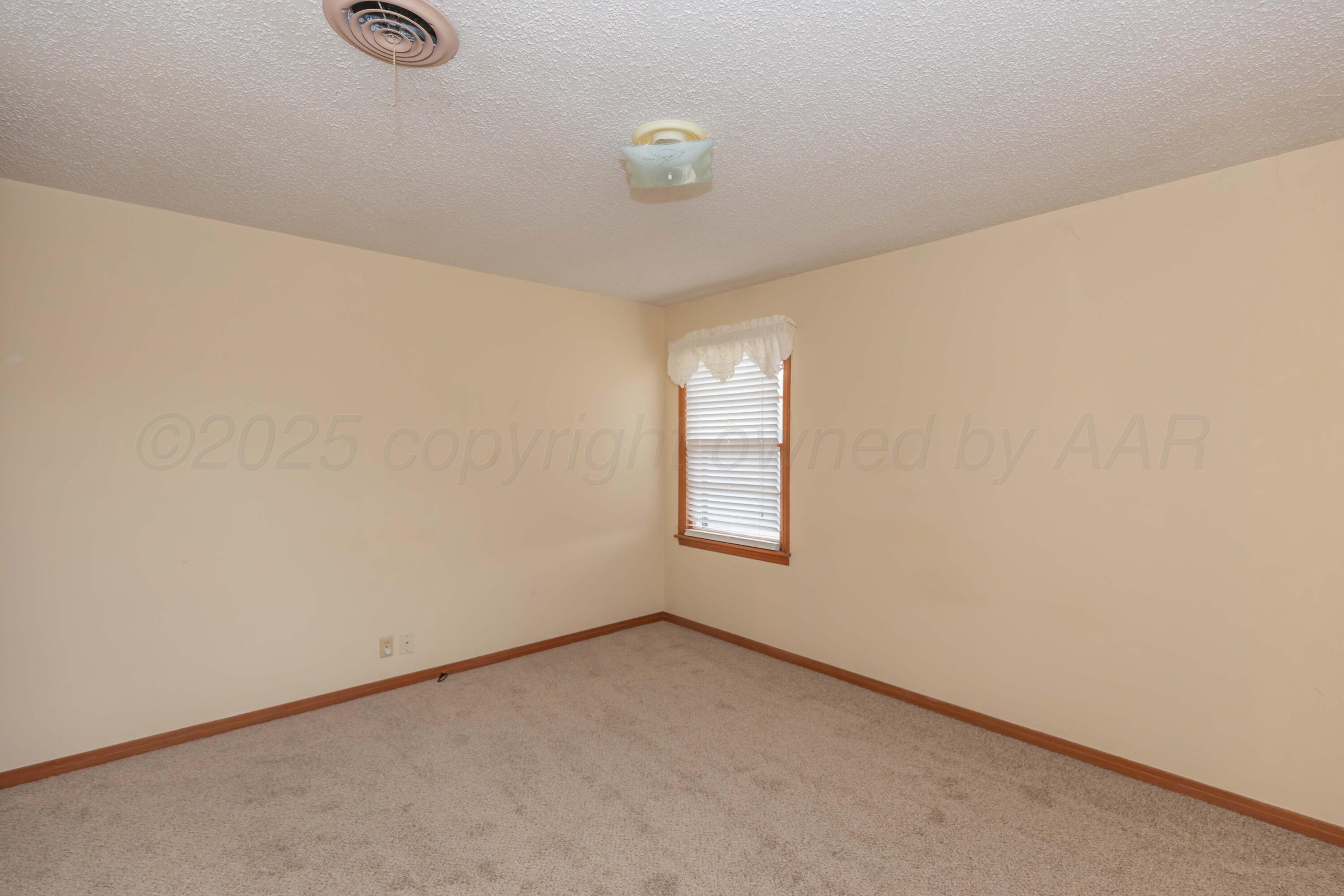 4221 Arden Road Amarillo, TX 79110 - Photo 22 of 50 a view of an empty room and window