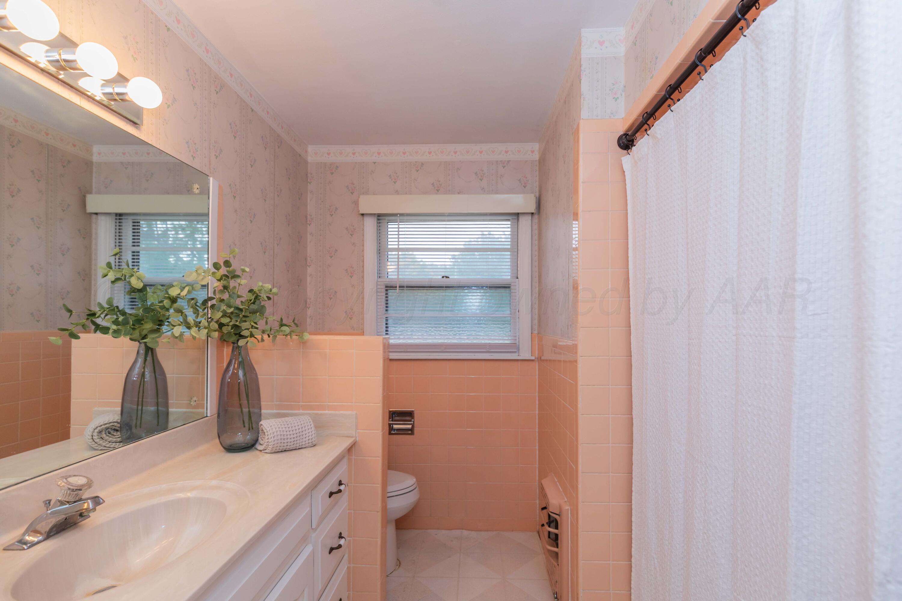4221 Arden Road Amarillo, TX 79110 - Photo 23 of 50 a bathroom with a granite countertop sink and a mirror