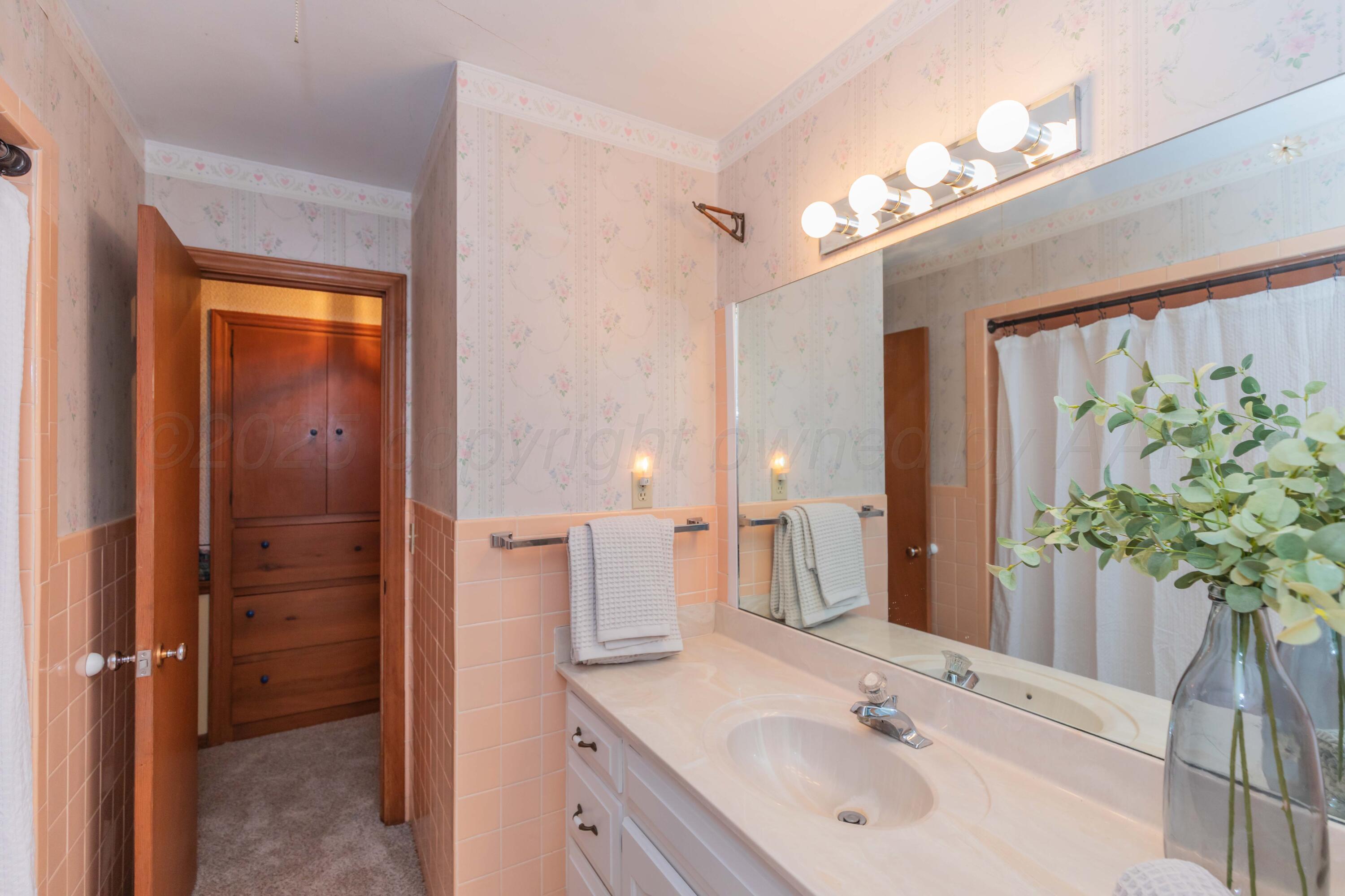 4221 Arden Road Amarillo, TX 79110 - Photo 25 of 50 a bathroom with a sink vanity and a mirror