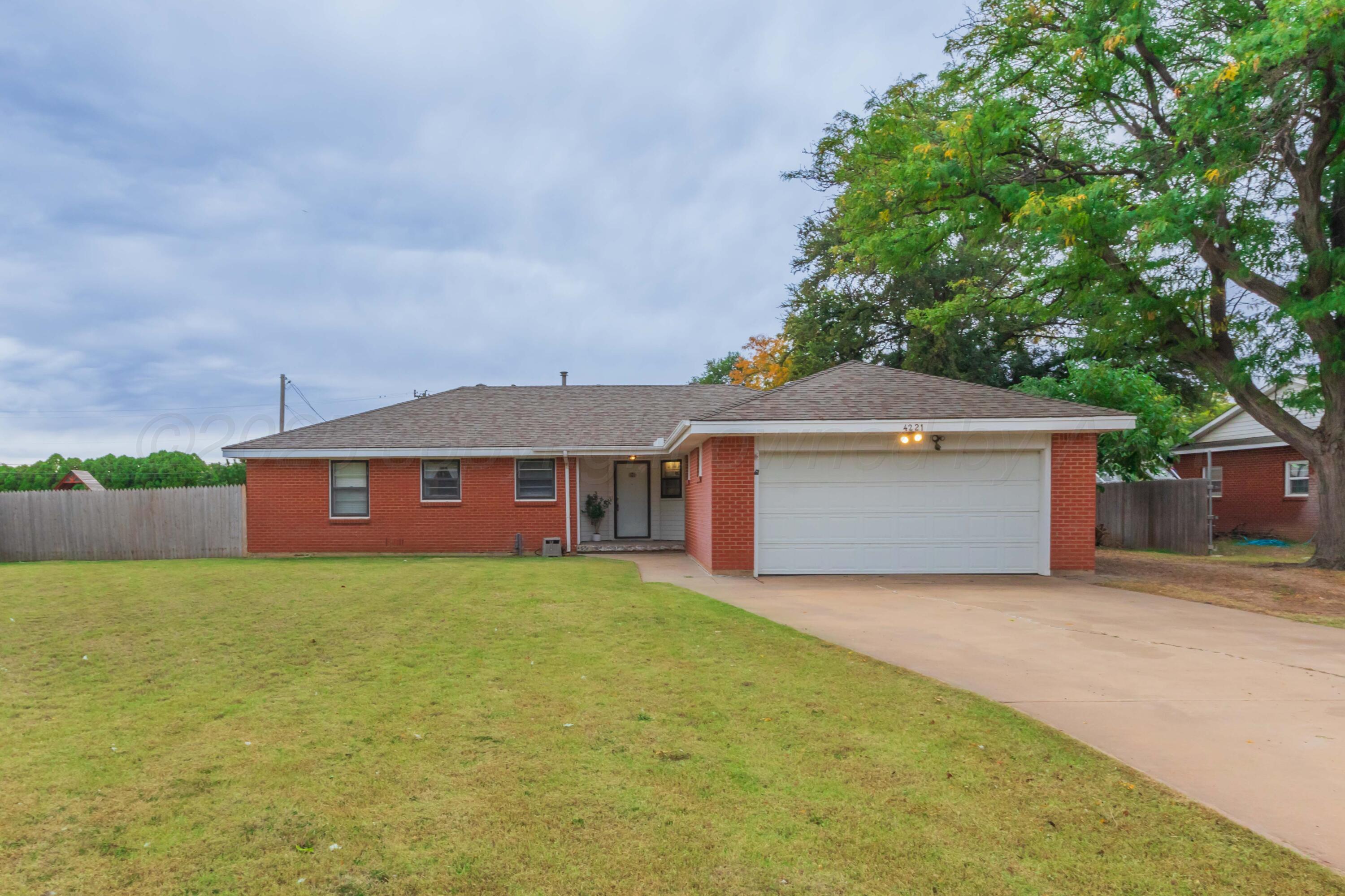4221 Arden Road Amarillo, TX 79110 - Photo 48 of 50 a front view of a house with yard and large trees