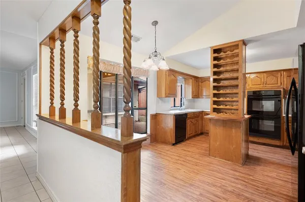 a kitchen with granite countertop stainless steel appliances and wooden cabinets