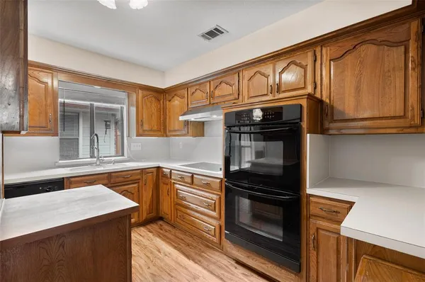 a kitchen with a sink and a refrigerator