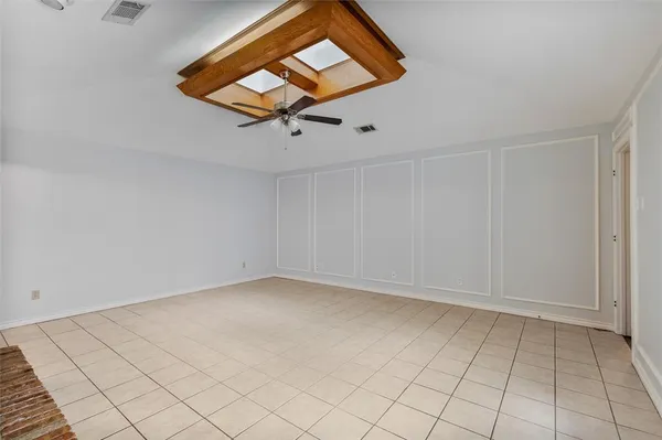 a view of a hallway with wooden floor and a ceiling fan