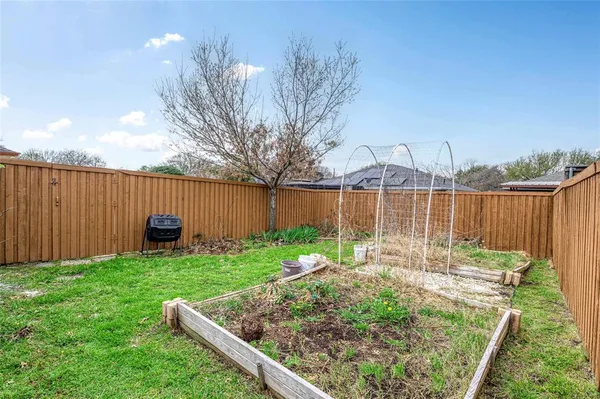 a backyard of a house with table and chairs