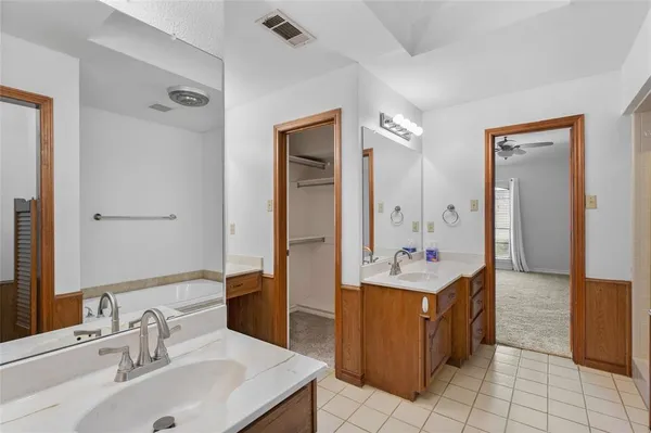 a bathroom with a tub and a window