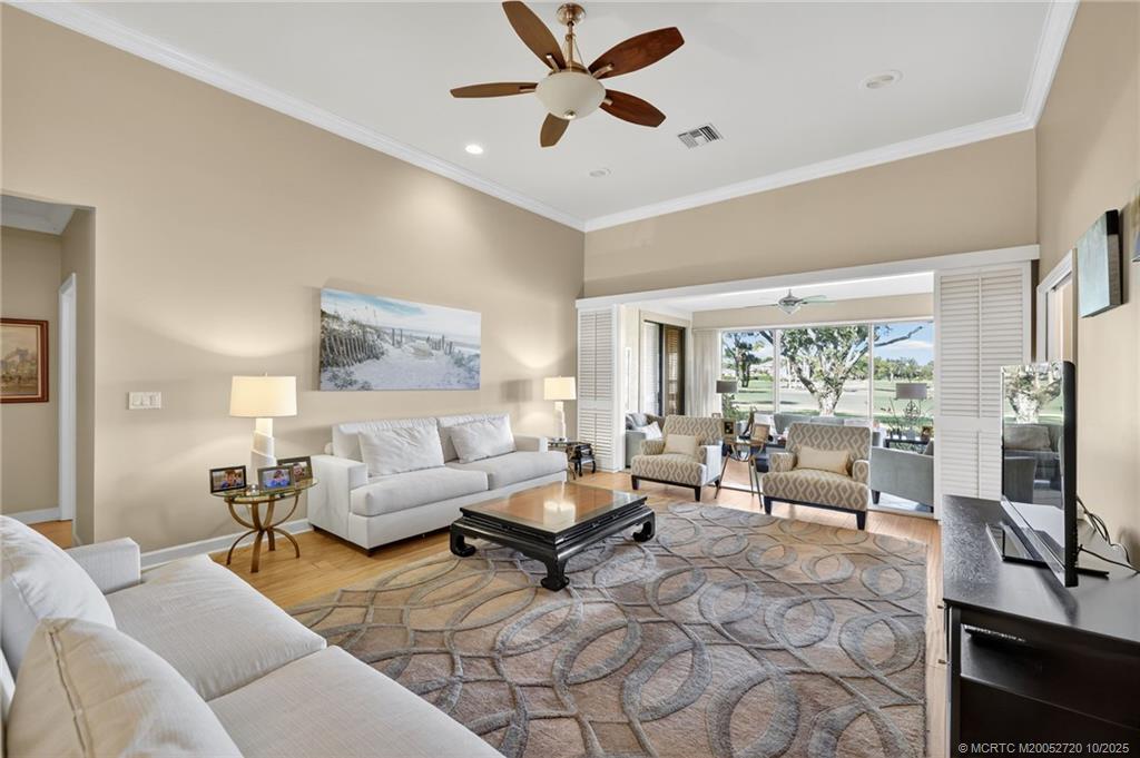 6957 Southeast Pacific Drive Stuart, FL 34997 - Photo 11 of 71 a living room with furniture and a flat screen tv