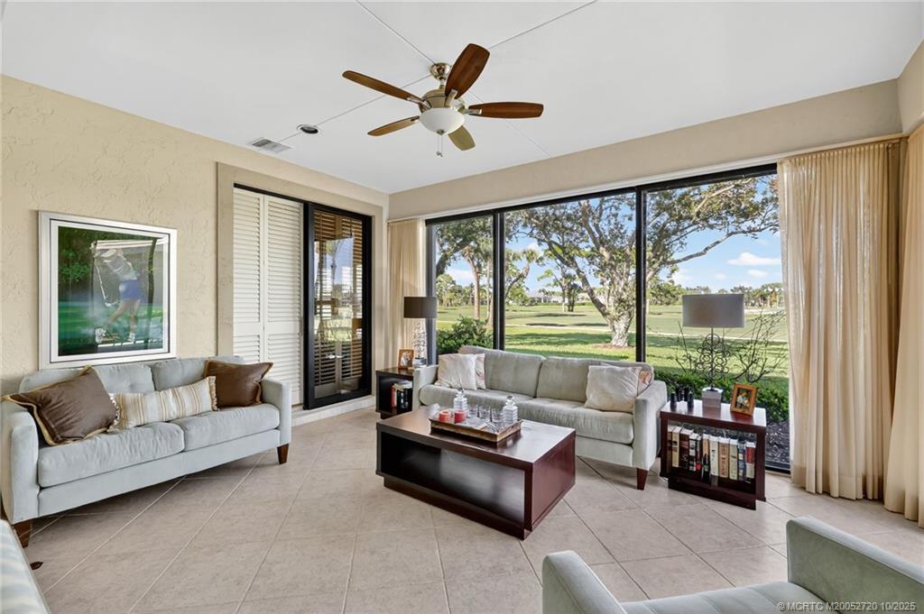 6957 Southeast Pacific Drive Stuart, FL 34997 - Photo 13 of 71 a living room with furniture and a large window