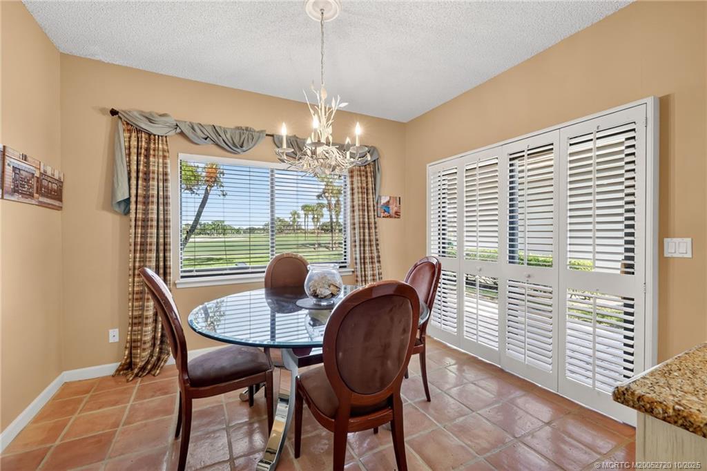 6957 Southeast Pacific Drive Stuart, FL 34997 - Photo 15 of 71 a dining room with furniture and window