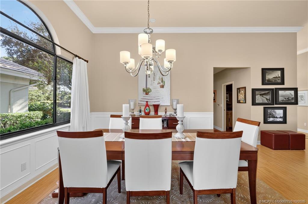 6957 Southeast Pacific Drive Stuart, FL 34997 - Photo 20 of 71 a dining room with furniture a window and wooden floor