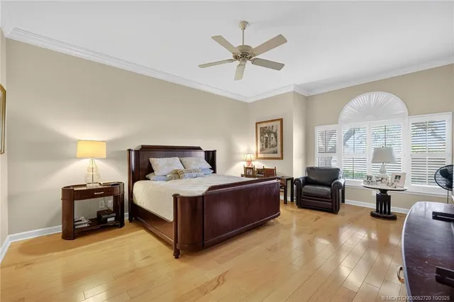 a spacious bedroom with a bed and a chandelier