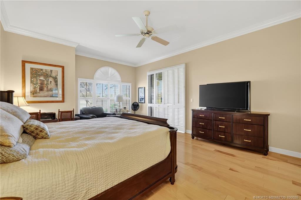 6957 Southeast Pacific Drive Stuart, FL 34997 - Photo 25 of 71 a bedroom with a bed and a flat screen tv