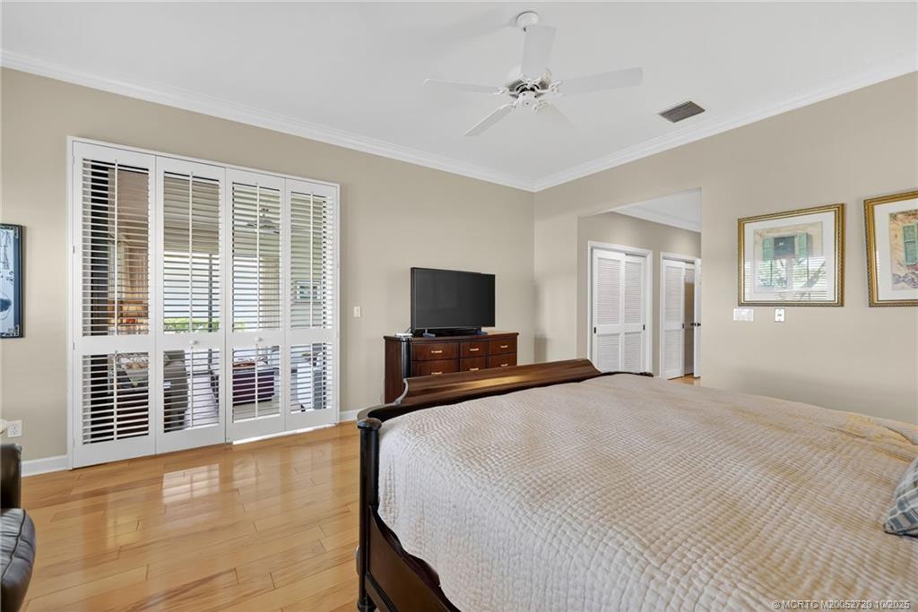 6957 Southeast Pacific Drive Stuart, FL 34997 - Photo 27 of 71 a bedroom with a bed and a flat screen tv