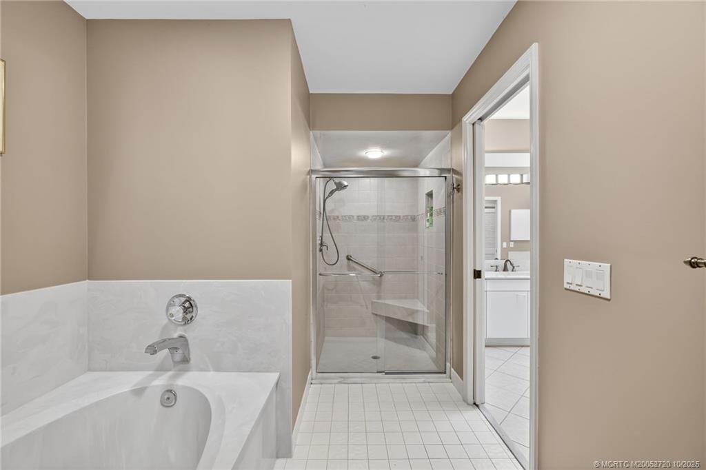 6957 Southeast Pacific Drive Stuart, FL 34997 - Photo 31 of 71 a bathroom with a bathtub and a shower