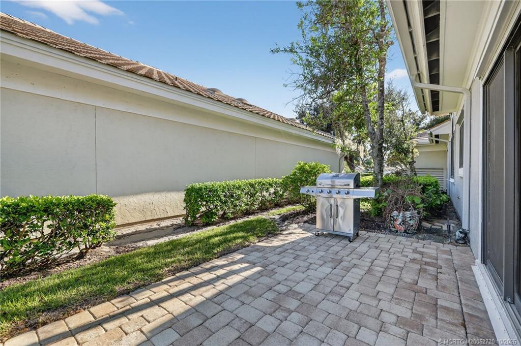 6957 Southeast Pacific Drive Stuart, FL 34997 - Photo 39 of 71 a view of a backyard with potted plants and plants