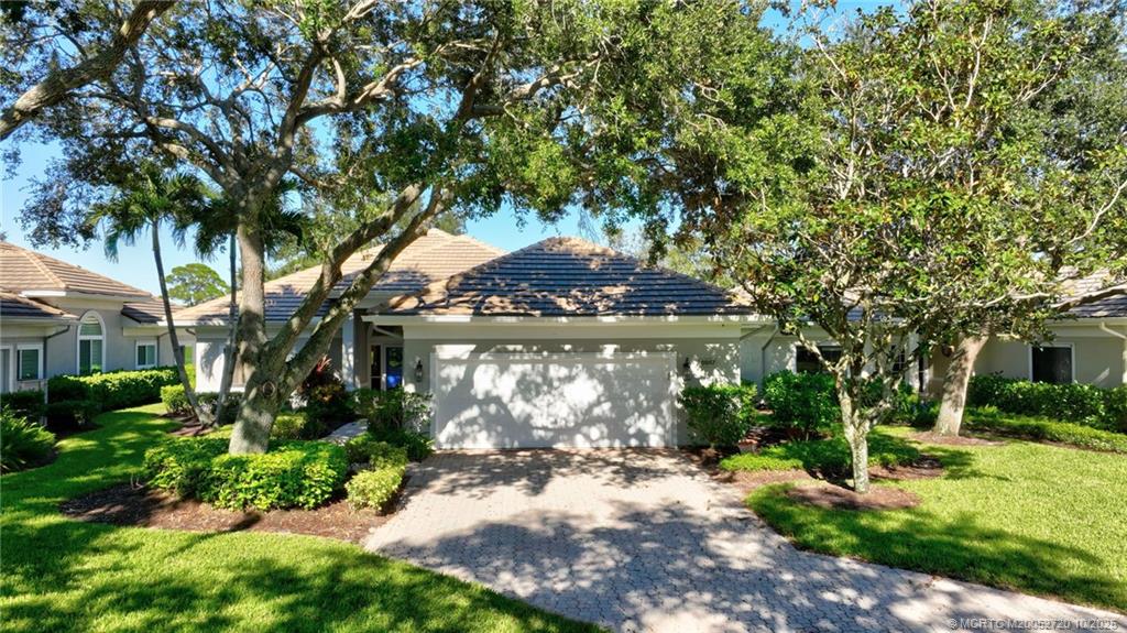 6957 Southeast Pacific Drive Stuart, FL 34997 - Photo 47 of 71 a front view of a house with garden