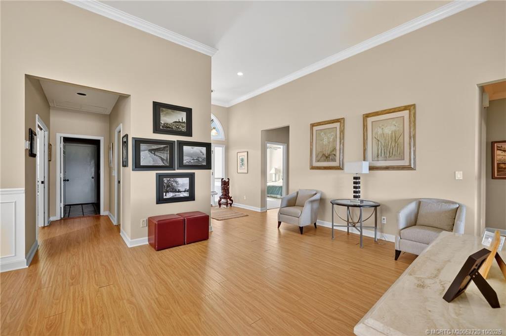 6957 Southeast Pacific Drive Stuart, FL 34997 - Photo 6 of 71 a living room with furniture and a wooden floor