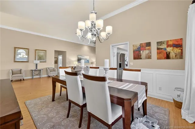 a view of a dining room with furniture and chandelier