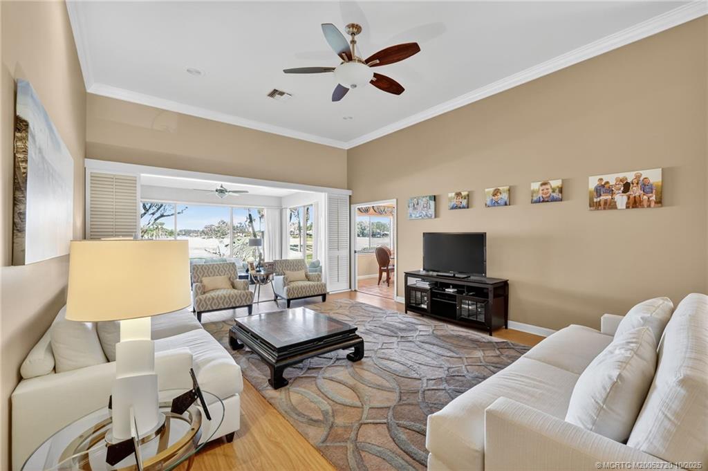 6957 Southeast Pacific Drive Stuart, FL 34997 - Photo 10 of 71 a living room with furniture and a flat screen tv