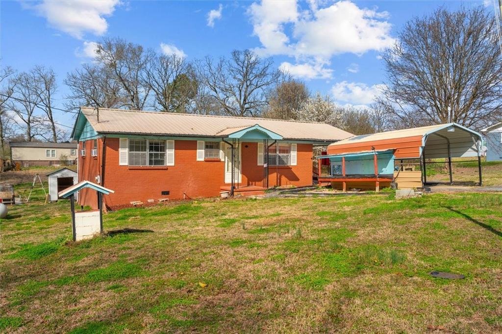 133 2nd Street Calhoun, GA 30701 - Photo 1 of 33 a view of a yard with a house in the background