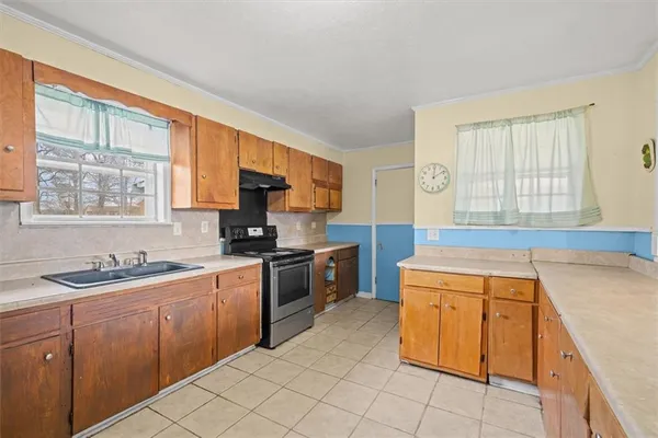 a kitchen with a sink stove top oven and cabinets